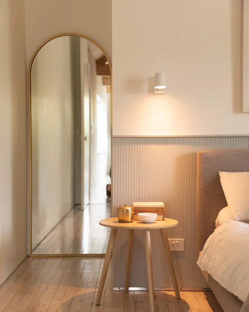 Cozy bedroom with feature wall and arch mirror, Interior Newcastle Local Home Renovation by Adapt Building