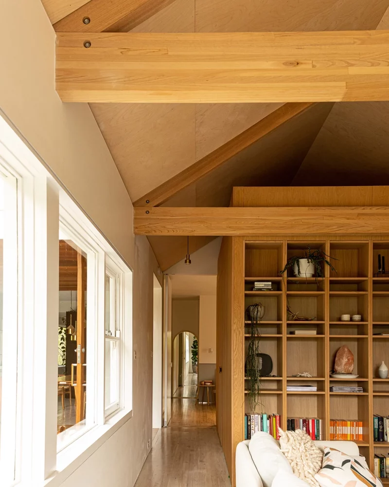 Renovated room with a full wall of custom timber bookshelves in Newcastle